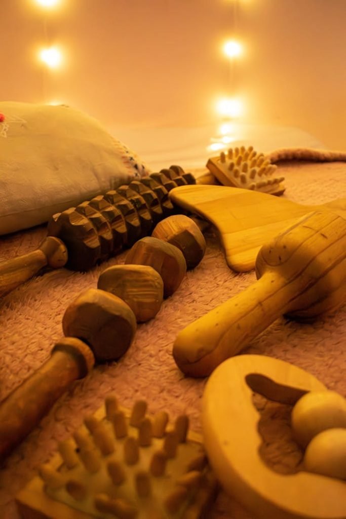 A soothing arrangement of wooden massage tools on a warm lit surface, ideal for relaxation.